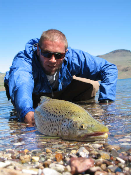 Picture of Rodrigo Amadeo fly fishing in Patagonia with a nice brown trout